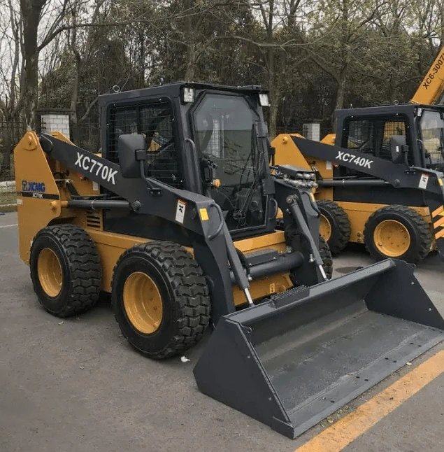 Onsite photograph of wheel skid steer loader working efficiently and productively.